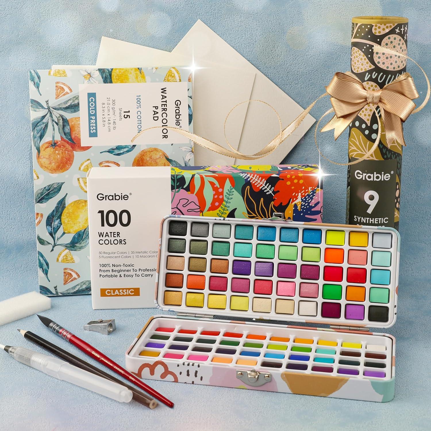 imageGrabie Watercolor Paint Set 100 Colors in Portable Box with Water Brush Pens Drawing Pencil Professional Watercolor Brushes and Watercolor Papers Perfect Starter Kit for Painting